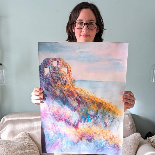 Person holding a colorful painting of a landscape