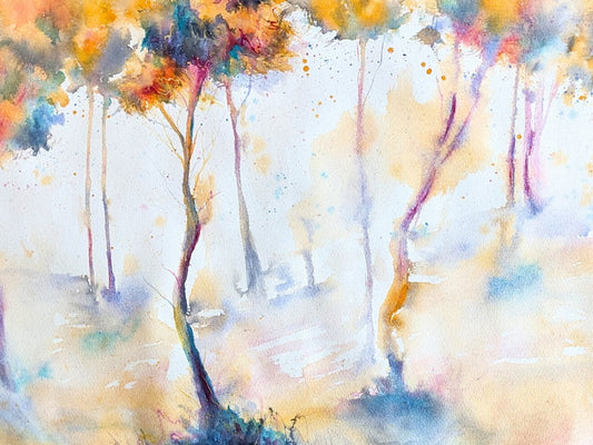 Detail shot of a watercolor painting of colorful trees in a misty forest from Tara Shoemaker Art