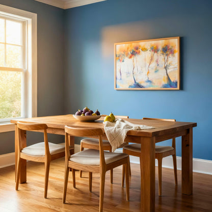 Dining room with wooden table and chairs against a blue wall with a painting.