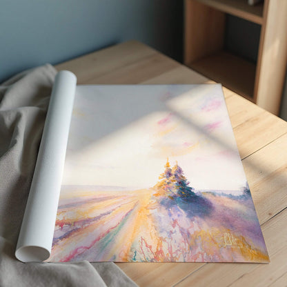 Rolled-up art print of a landscape with trees on a wooden surface.