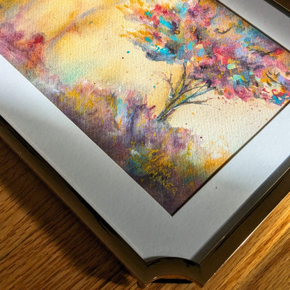 Framed abstract painting with colorful brushstrokes on a wooden surface