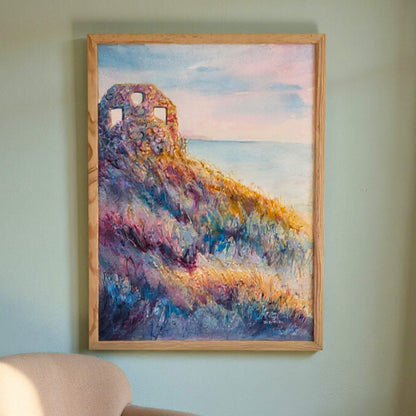 Framed painting of a colorful landscape with a ruin on a wall.