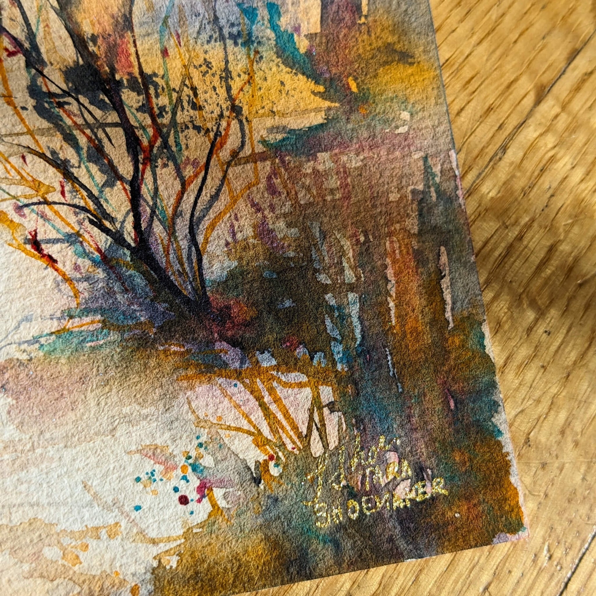 Artistic depiction of a landscape with trees and artist signature on a textured surface