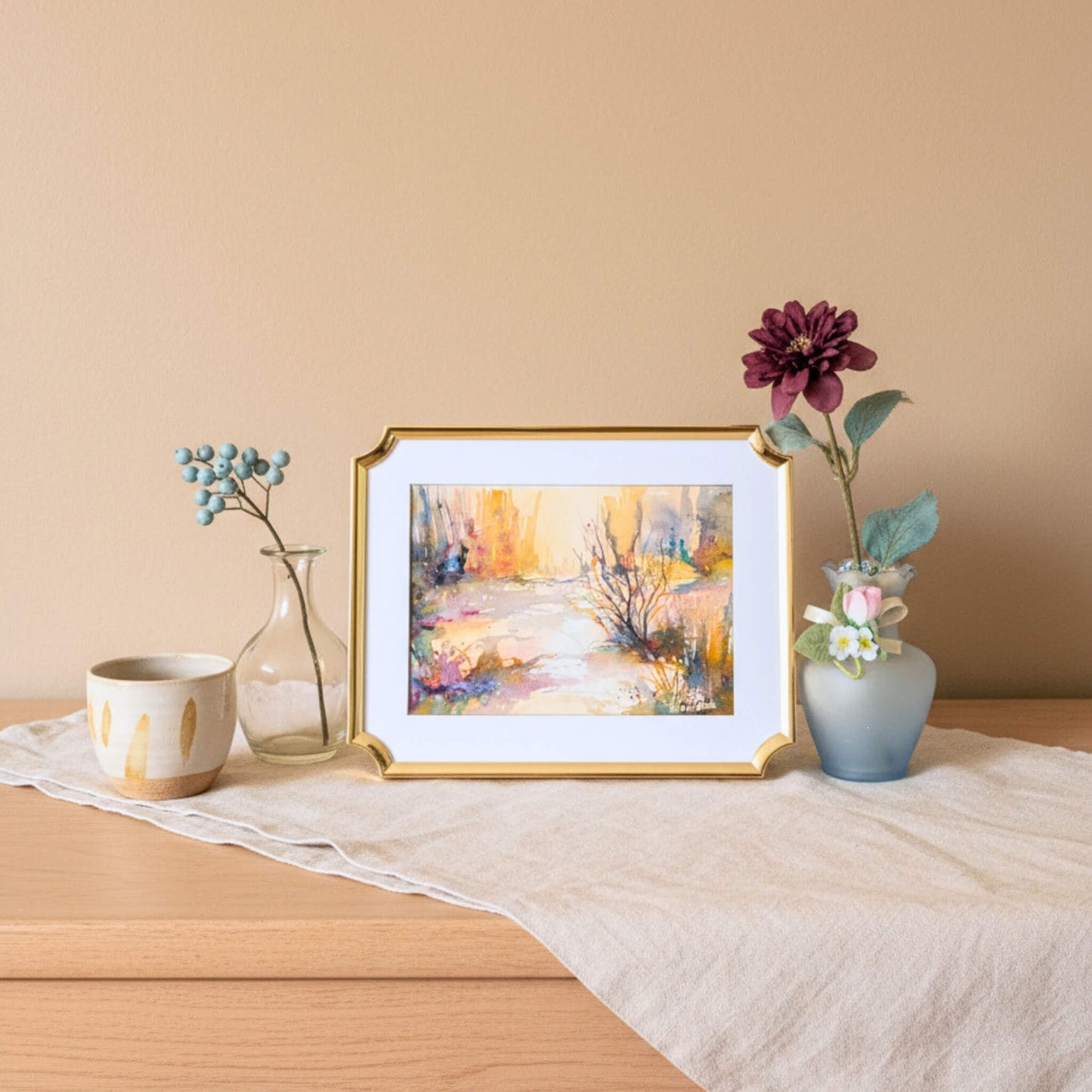 Framed artwork on a table with decorative items