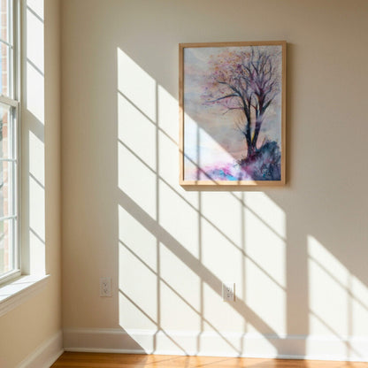 Framed artwork of a tree on a wall with sunlight casting shadows