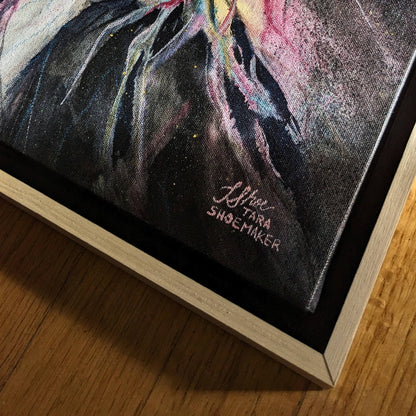 Close-up of a painting with 'Tara Shoemaker' signature on a wooden surface