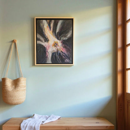 Framed abstract painting on a wall with a woven bag and wooden bench below.