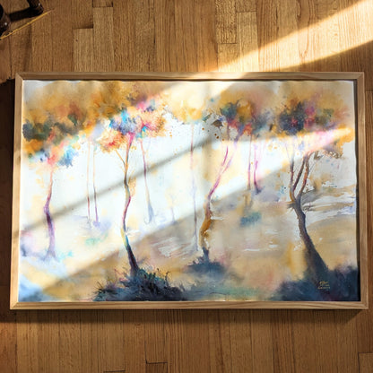 Video zooming in on abstract colorful watercolor painting with trees.