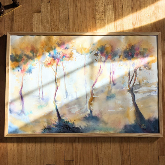 Video zooming in on a framed abstracted landscape with colorful golden trees.