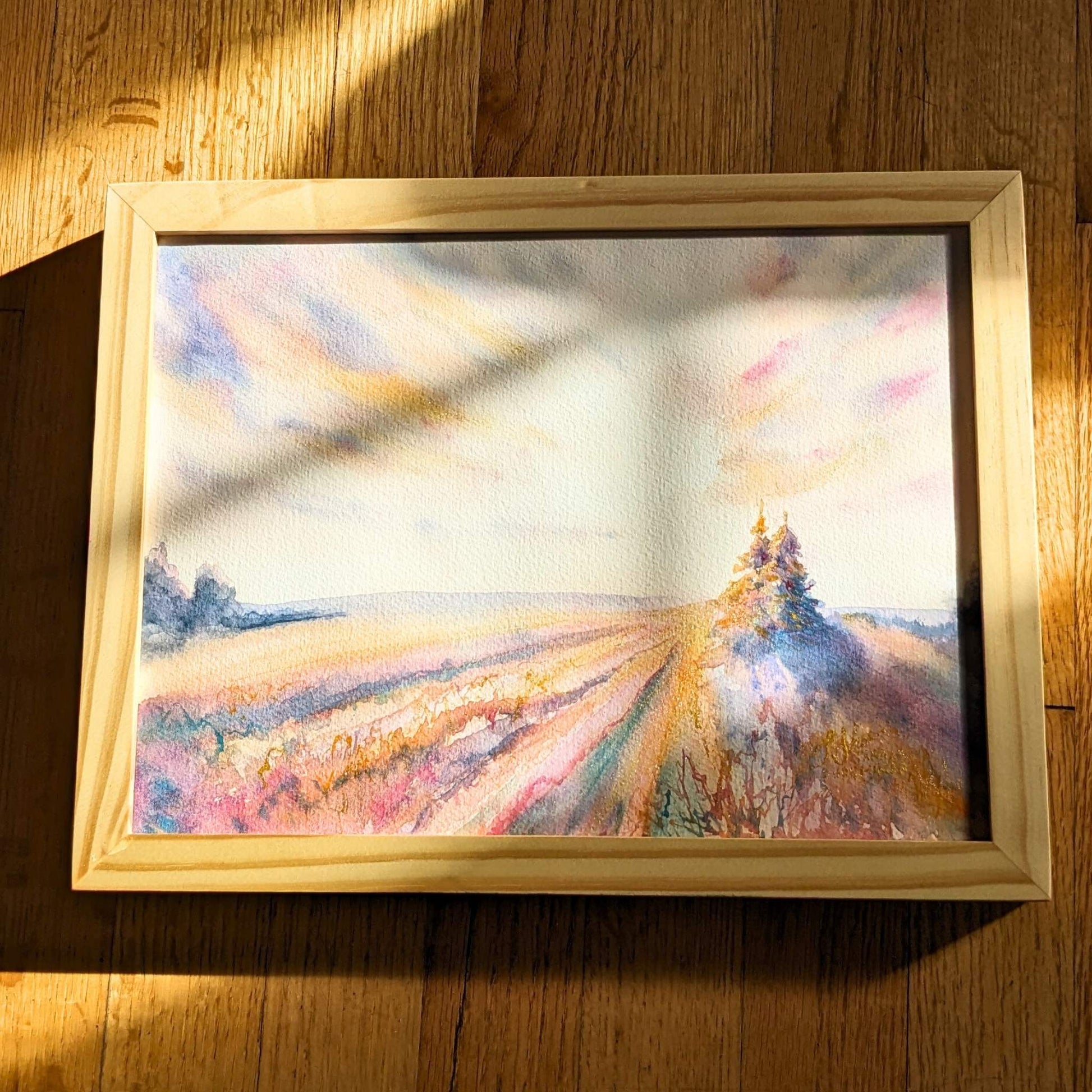 Video zooming in on abstract watercolor landscape with trees and a field.