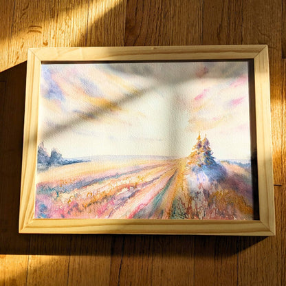 Video zooming in on a colorful landscape with trees in a field with soft pastel colors