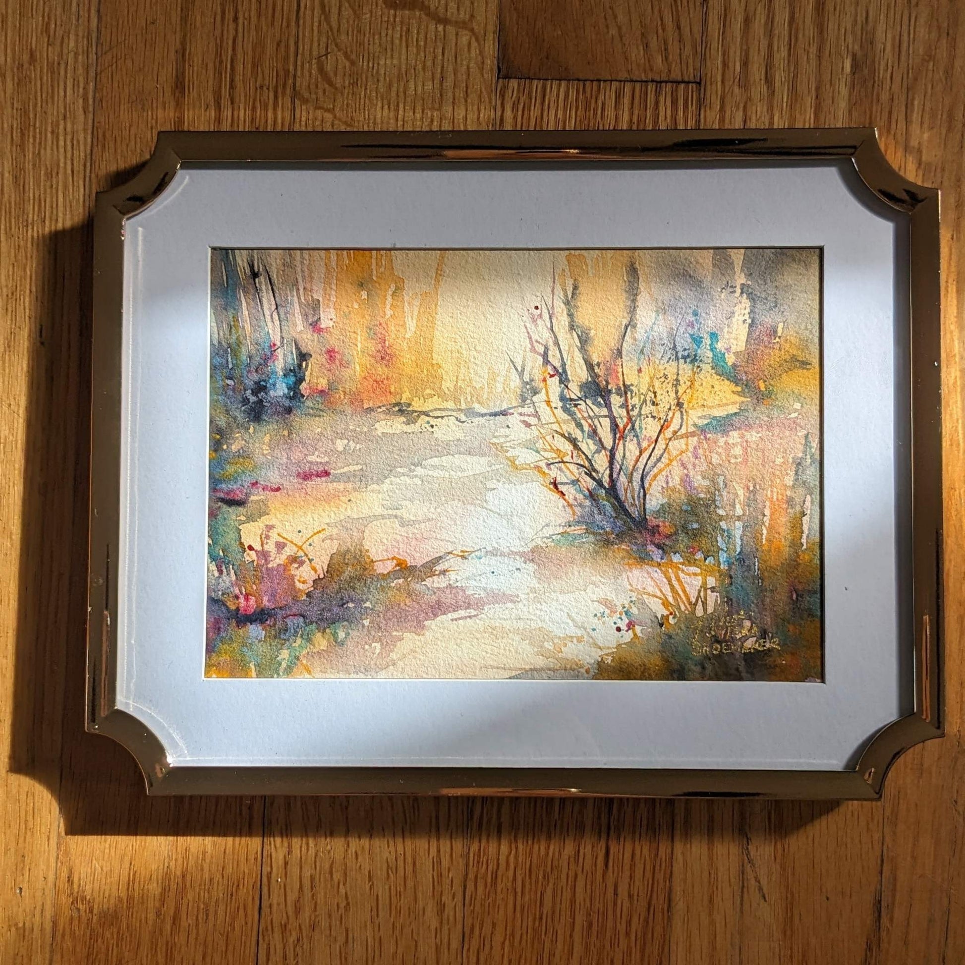 Video zooming in on a golden abstract watercolor landscape.