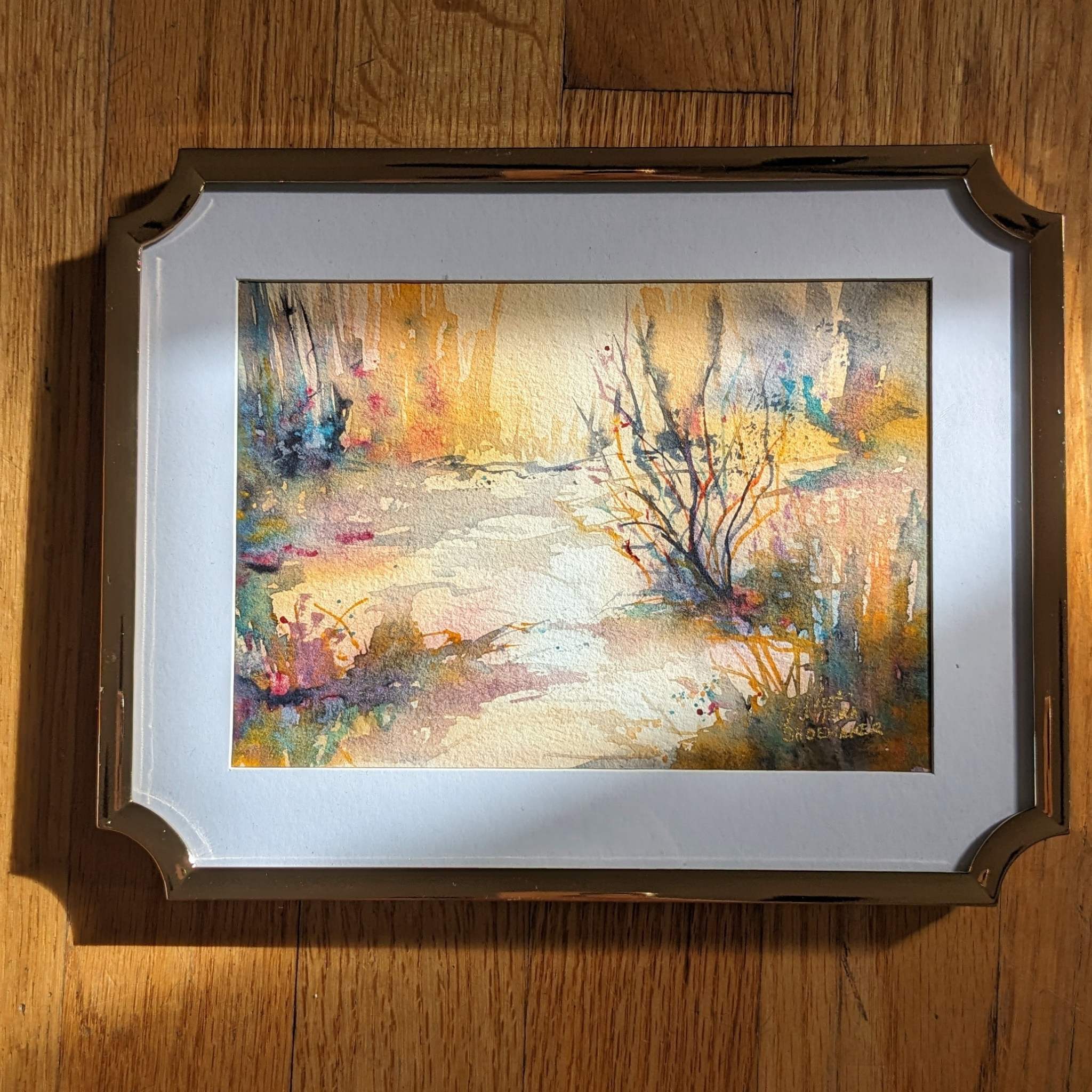 Video zooming in on a golden abstract watercolor landscape.