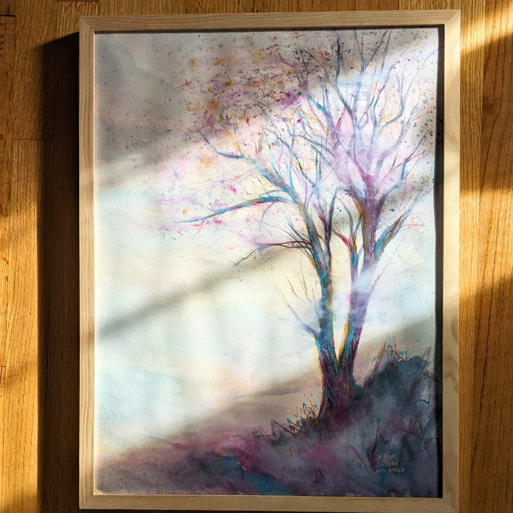 Video zooming in on a colorful abstract painting with a tree.